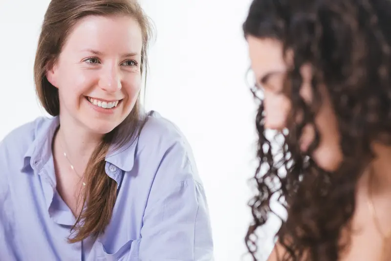 A Nyki tutor in conversation with a student